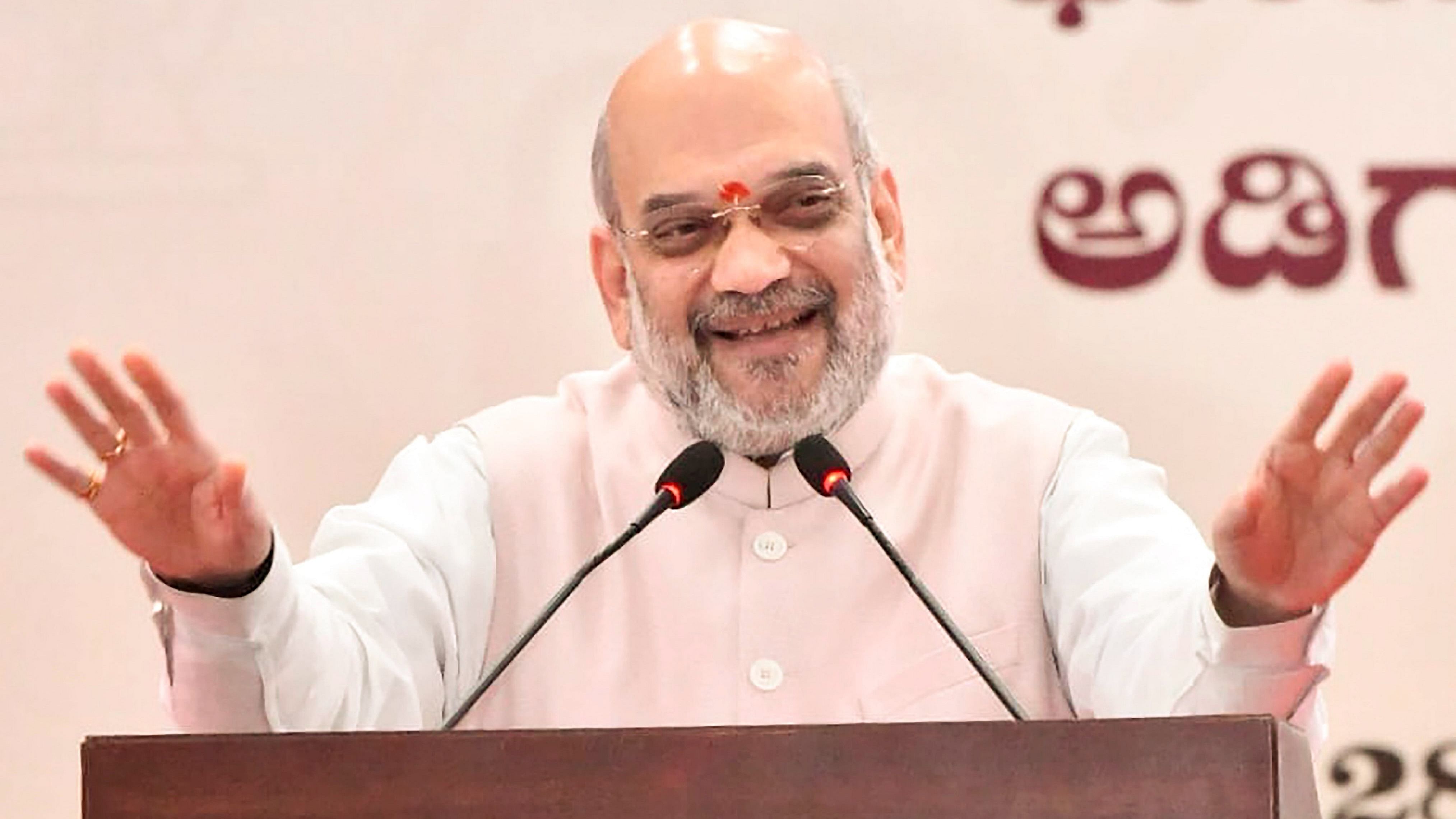 Amit Shah speaks during the foundation stone laying ceremony of the Forensic Science University in Dharwad. Credit: PTI Photo