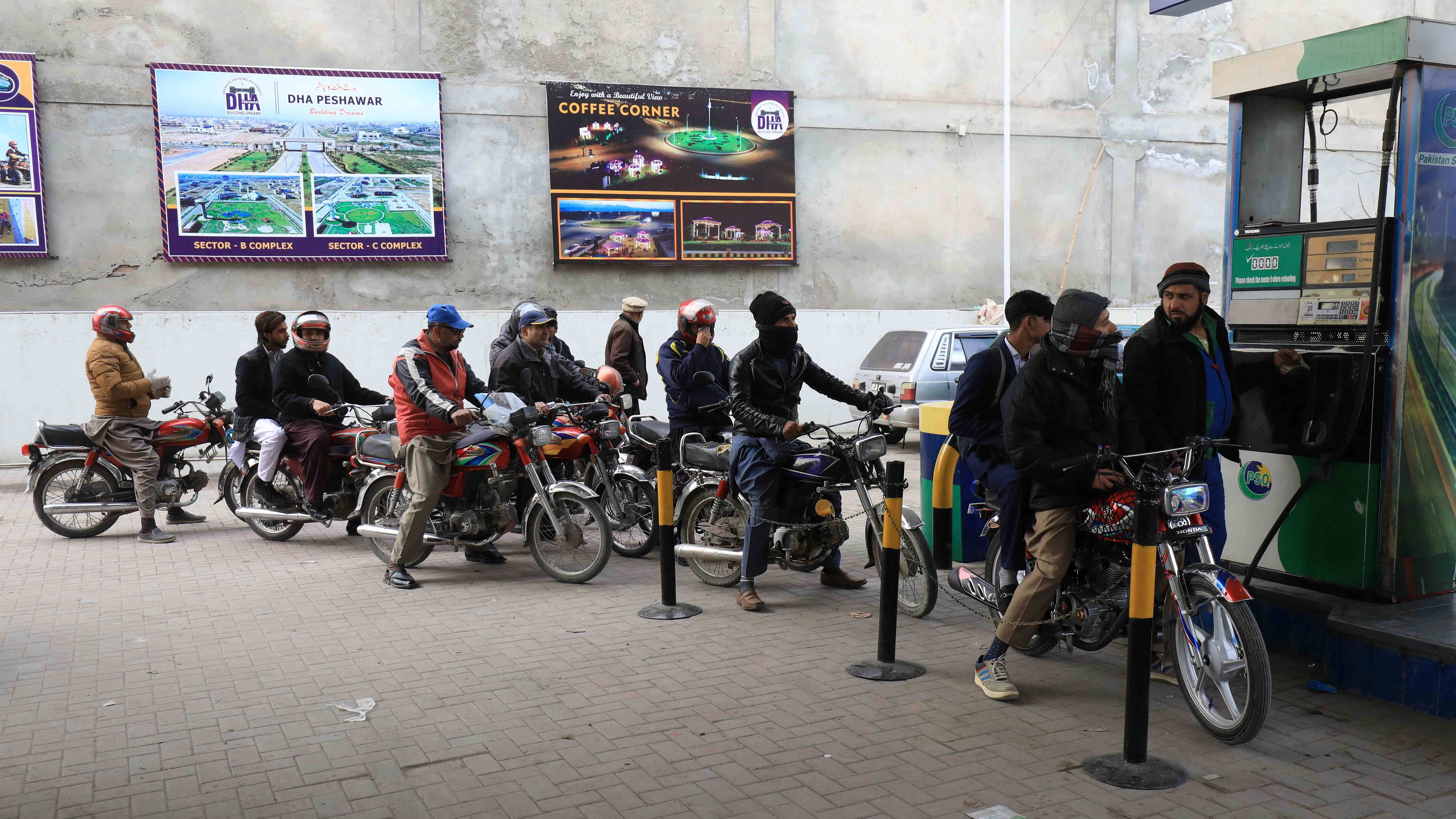 People wait for their turn to get fuel at a petrol station in Peshawar, Pakistan. Credit: Reuters Photo