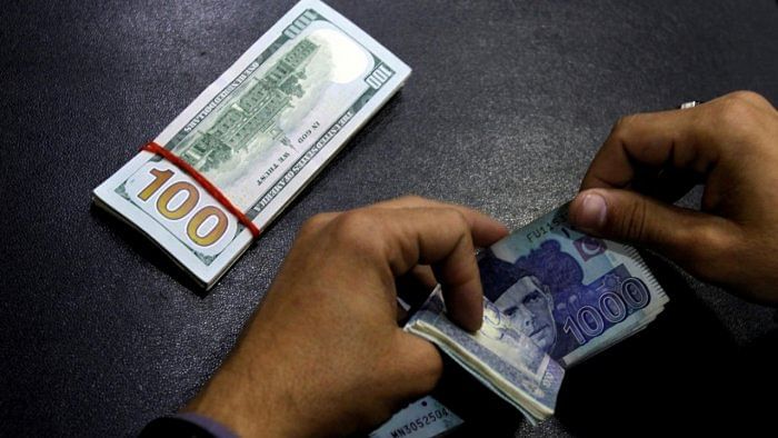 A currency trader counts Pakistani Rupee notes as he prepares an exchange of US dollars. Credit: Reuters File Photo 