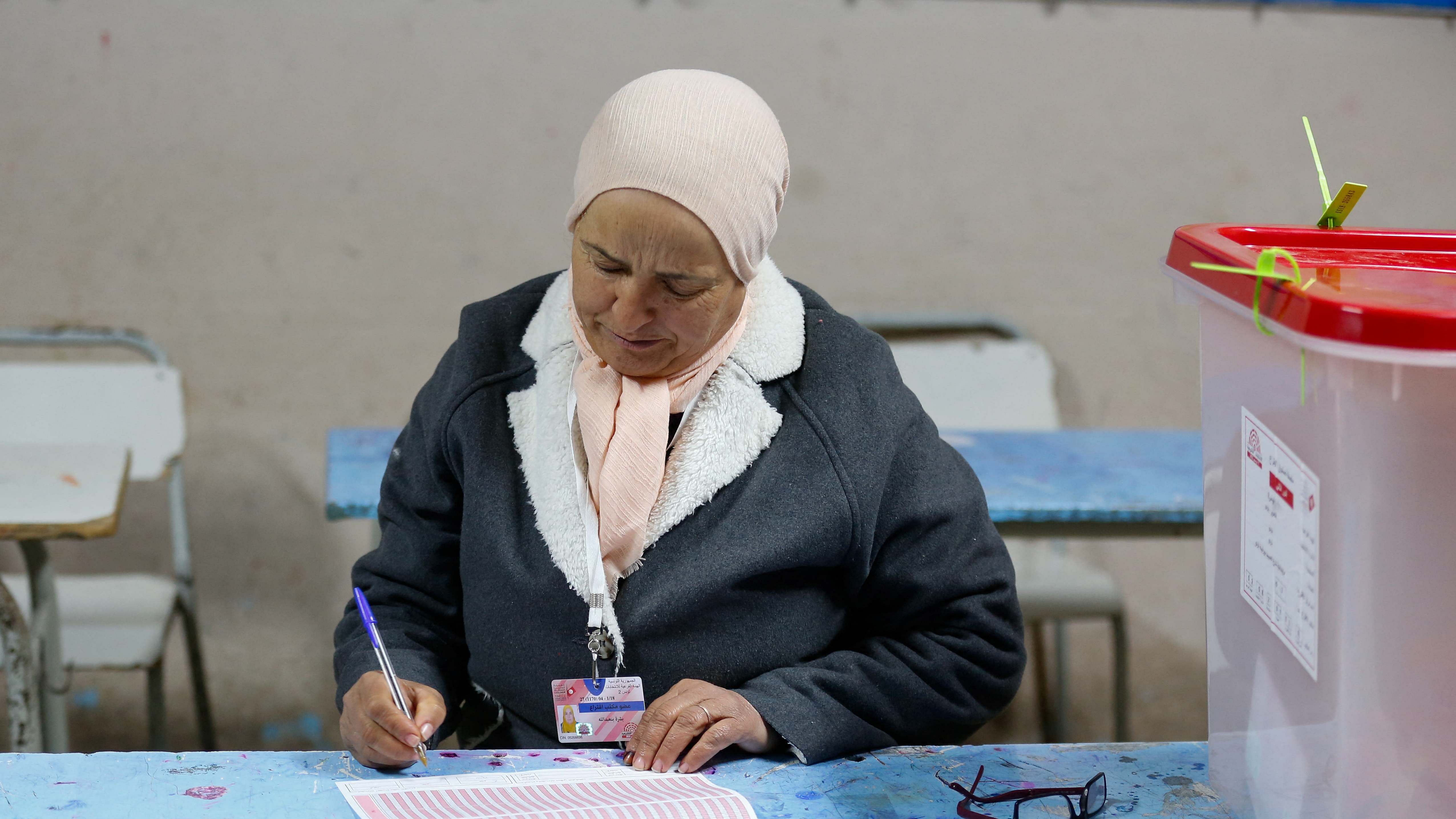 A member of the election committee works next to a closed ballot box at a polling station during the second round of the parliamentary election in Tunis, Tunisia January 29. Credit: Reuters Photo