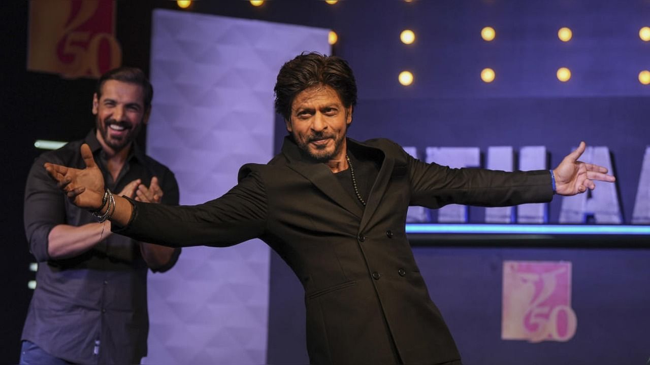 Bollywood superstar Shah Rukh Khan creates his signature pose at a press conference of movie 'Pathaan'. credit: PTI Photo