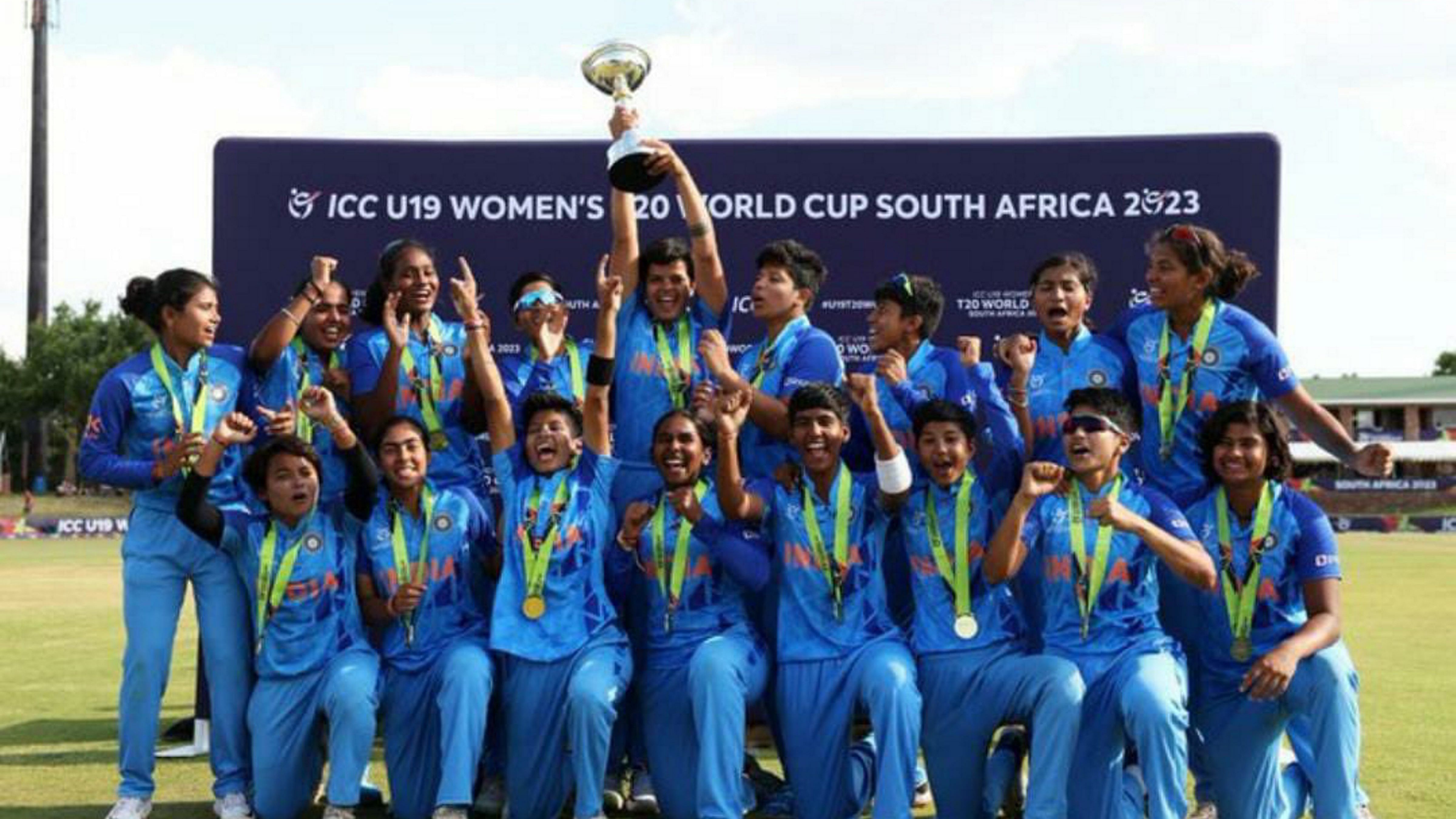 Indian U-19 women's cricket players celebrate with T20 world cup trophy after winning over England, in South Africa's Potchefstroom. Credit: PTI Photo
