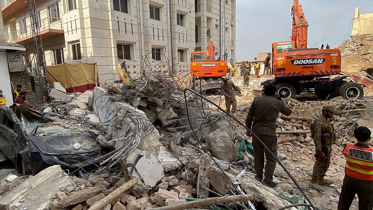 Authorities use heavy machinery to clear the rubble and search for victims a day after a suicide blast at a mosque inside the police headquarters in Peshawar. Credit: AFP Photo