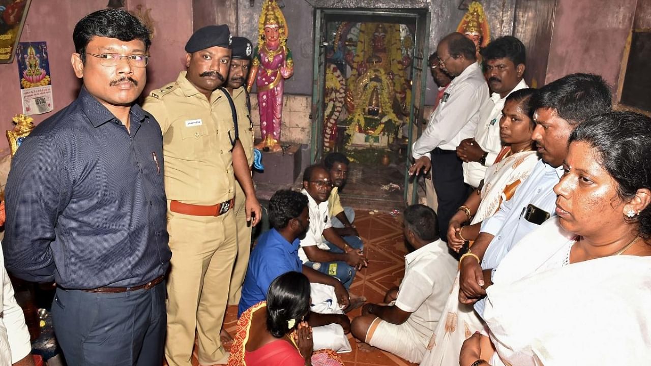 Dalits at a village temple amid tight police security following 'peace' talks facilitated by the district authorities with dominant castes. Credit: PTI Photo