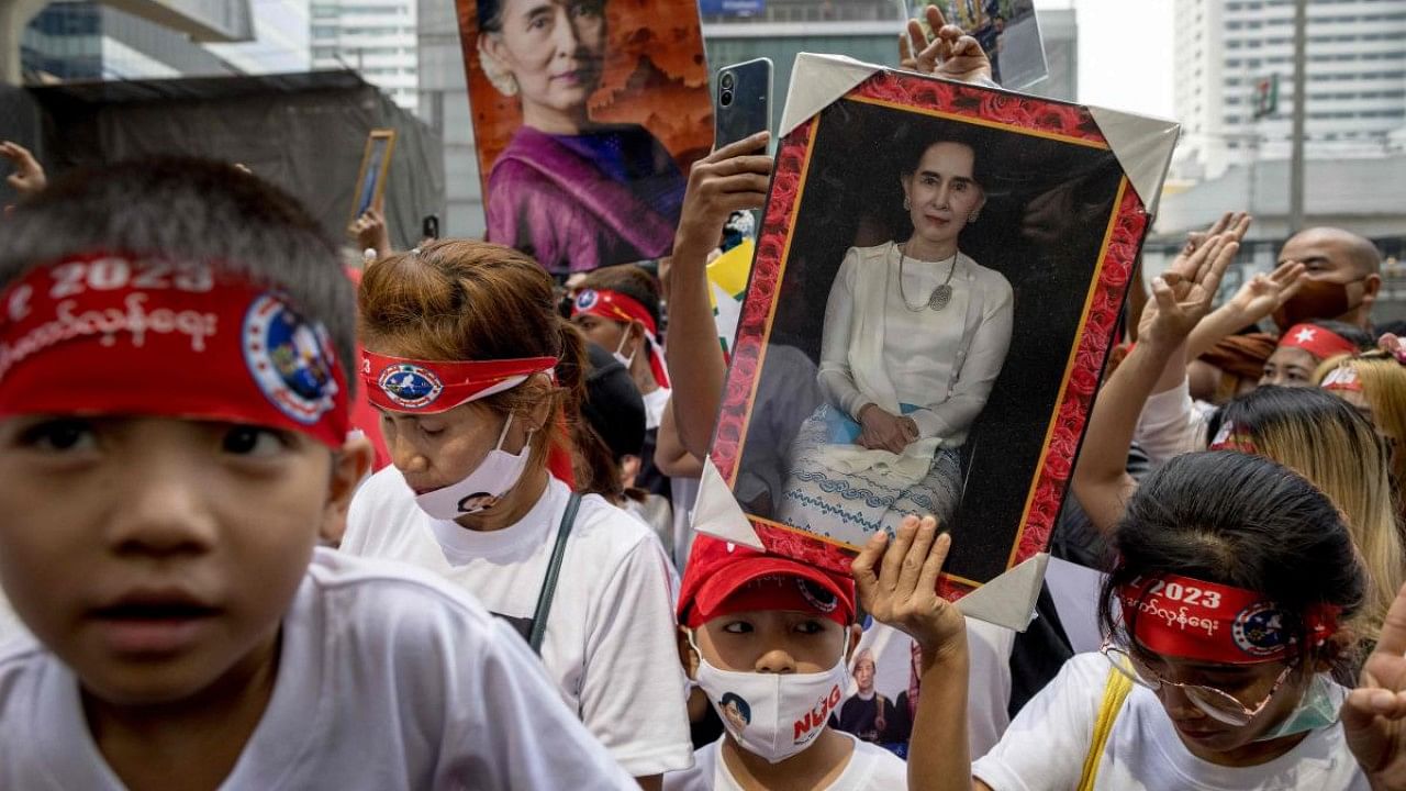 Protesters hold images of detained civilian leader Aung San Suu Kyi during a demonstration outside the Embassy of Myanmar in Bangkok. Credit: AFP Photo