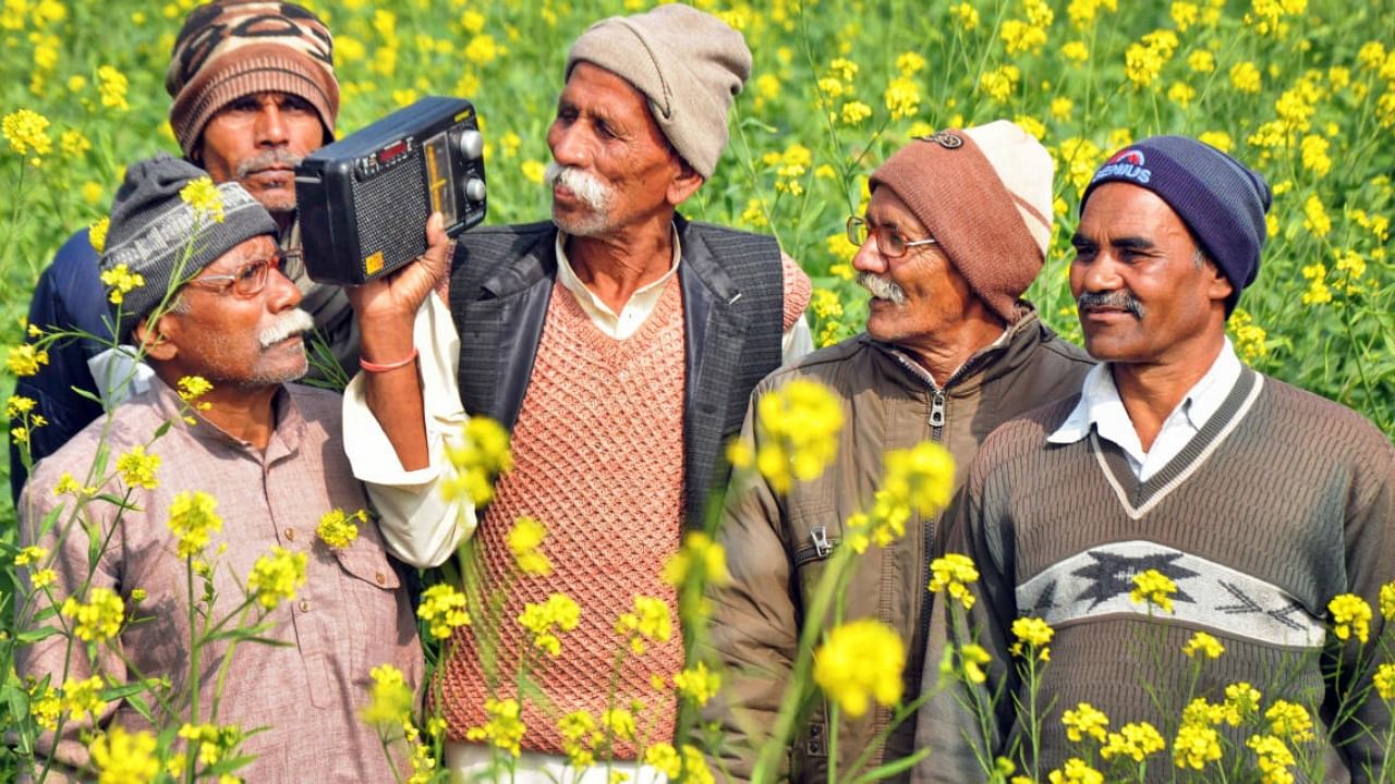 Farmers listen to the radio broadcast of FM Nirmala Sitharaman presenting the Union Budget 2023-24. credit: PTI Photo