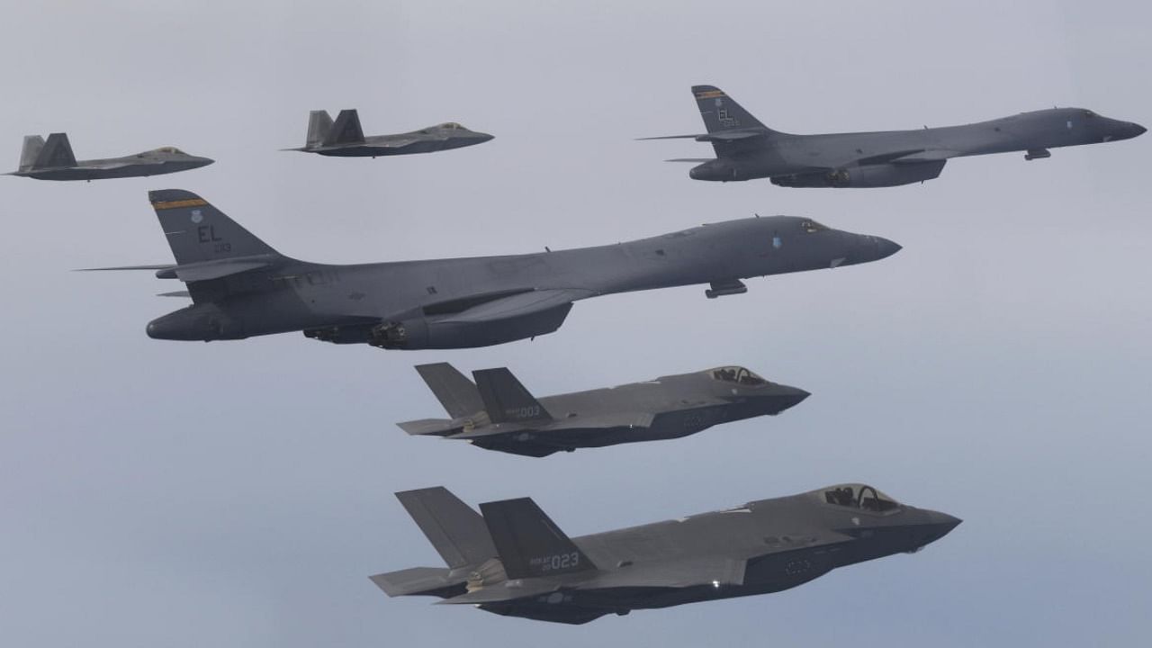 US Air Force B-1B bombers, center, F-22 fighter jets and South Korean Air Force F-35 fighter jets, bottom, fly over South Korea Peninsula during joint air drill. Credit: AP/PTI Photo