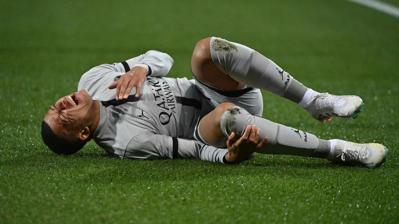 Paris Saint-Germain's French forward Kylian Mbappe lies on the ground after getting injured. Credit: AFP Photo