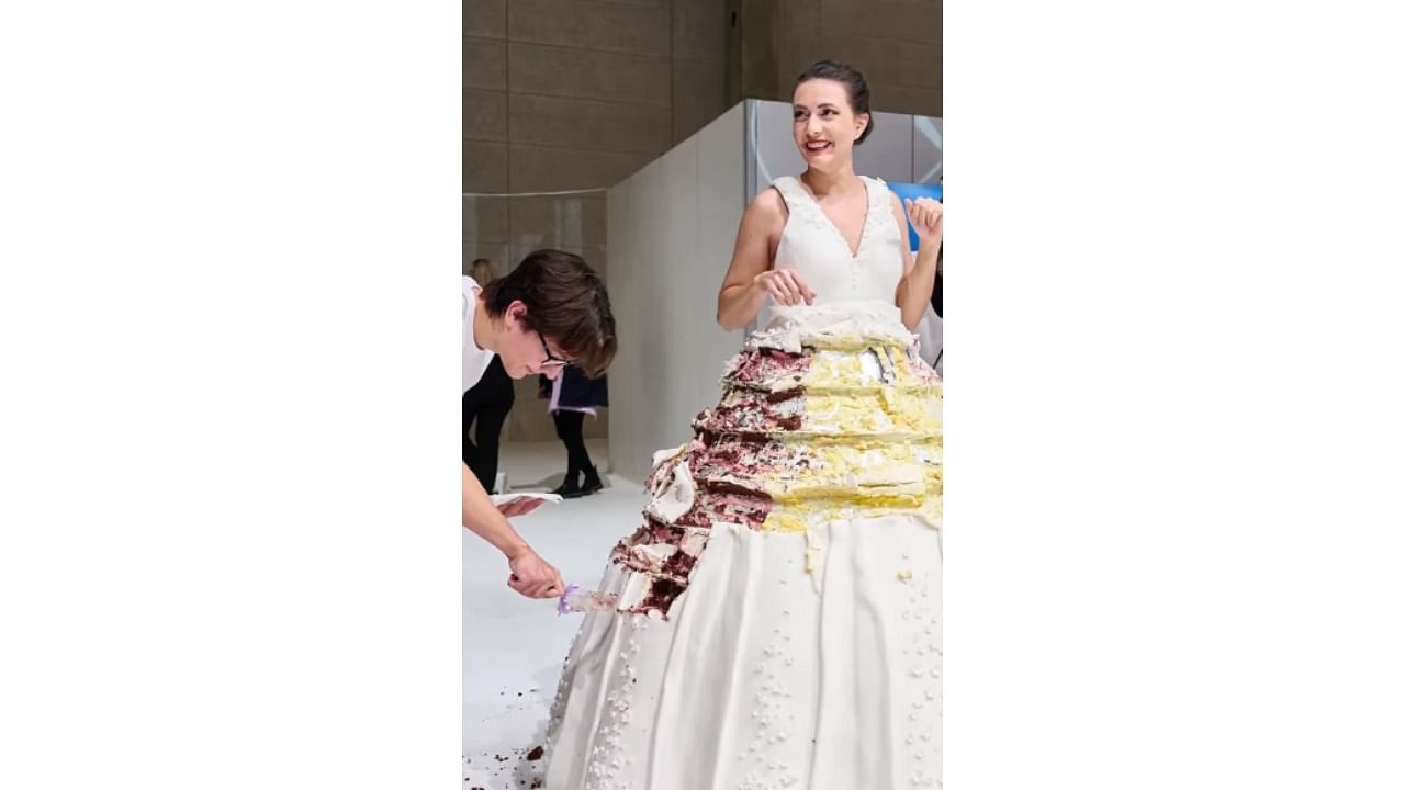 The caption said, "Largest wearable cake dress (supported) 131.15 kg (289 lb 13 oz) by Natasha Coline Kim fah Lee Fokas, SweetyCakes." Credit: Instagram/@guinnessworldrecords