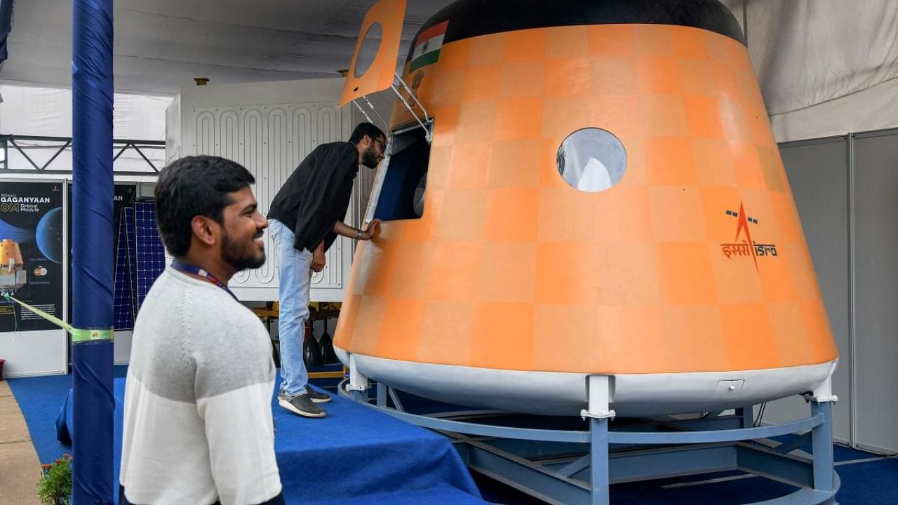Visitors look at an actual scale model of “Gaganyaan Orbital Module”, India’s first manned space flight at the Human Space Flight Expo organised by the Indian Space Research Organisation (ISRO) at the Jawaharlal Nehru Planetarium in Bangalore on July 21, 2022. Credit: PTI Photo