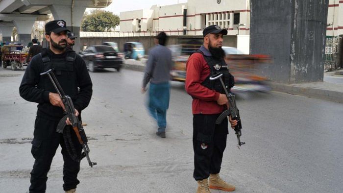 Policemen stand guard along a street in Peshawar on February 1, 2023, days after a mosque suicide blast inside a police headquarters. Credit: AFP Photo