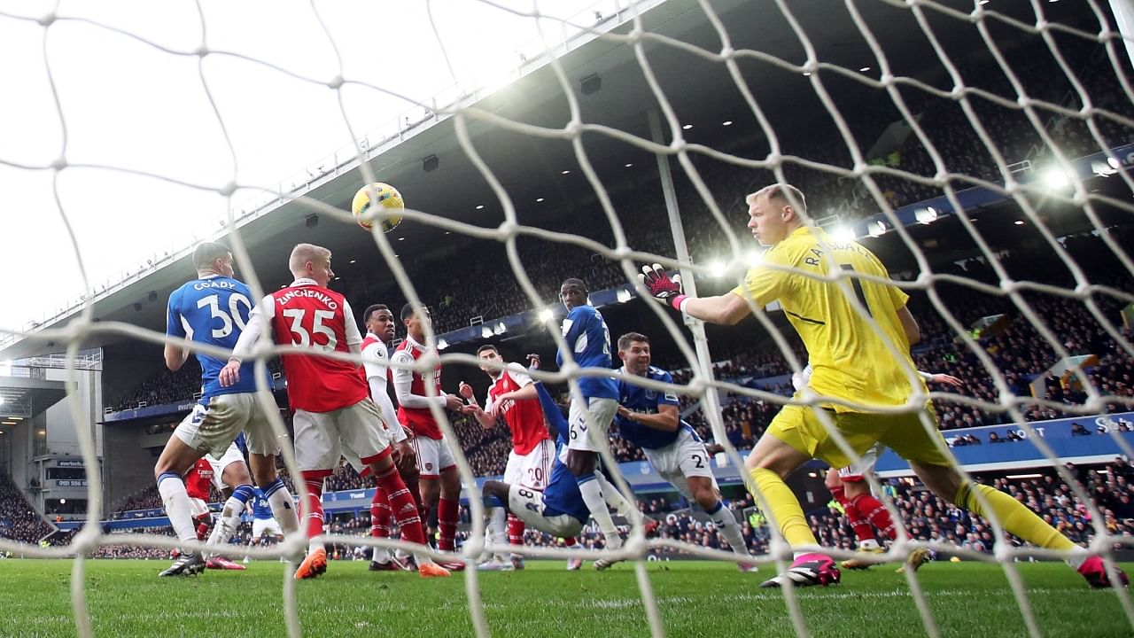 Everton's James Tarkowski scores past Arsenal's Aaron Ramsdale. Credit: Reuters Photo
