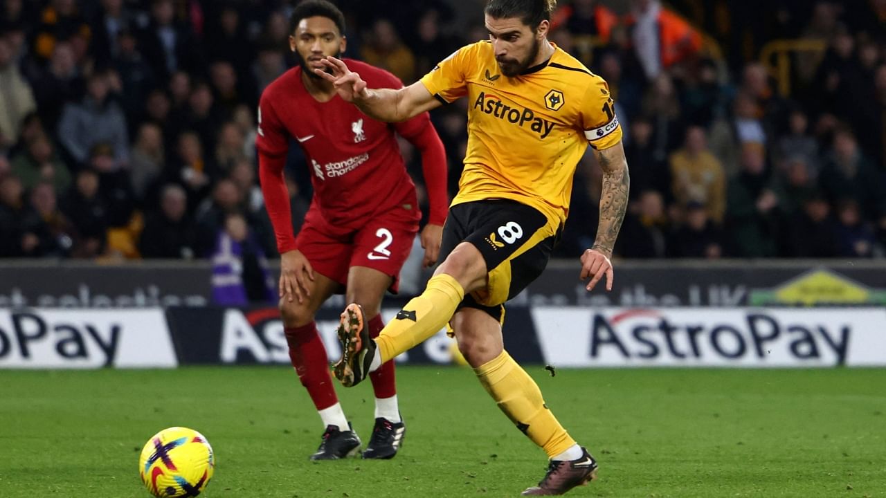 Wolves midfielder Ruben Neves scores his team's third goal against Liverpool. Credit: AFP Photo