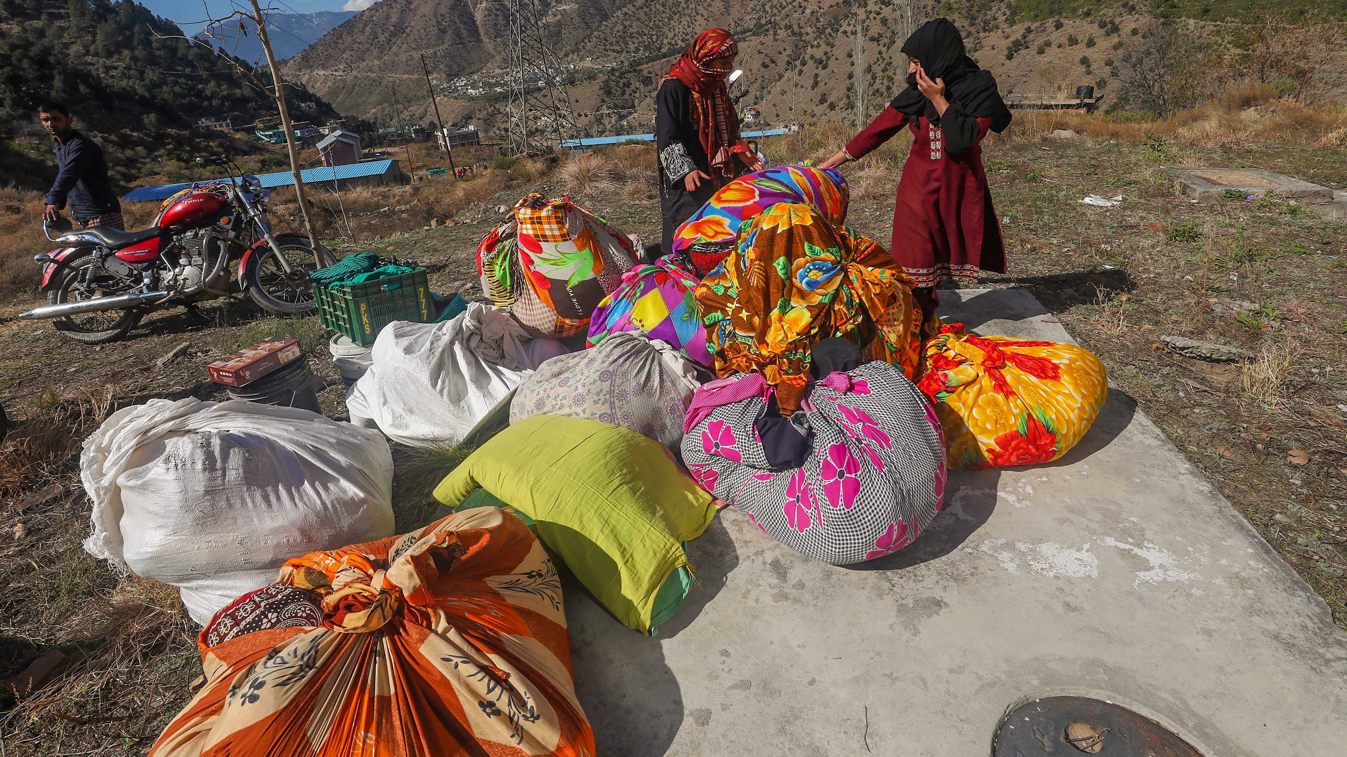 Residents shift with their goods from their unsafe home in land subsidence affected Nai Basti area, in Doda district, Jammu & Kashmir. Credit: PTI Photo