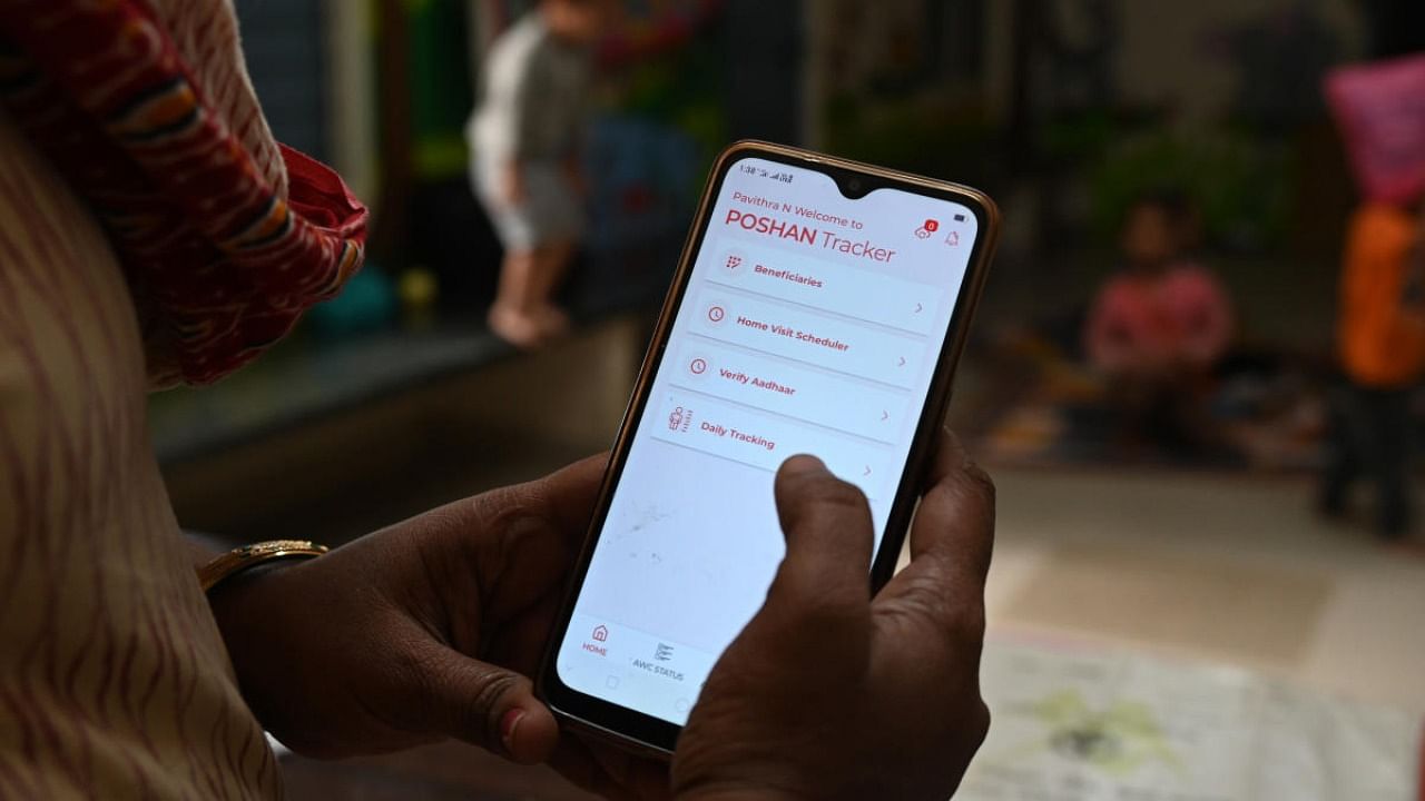 An Anganwadi worker in Bengaluru records data on the POSHAN Tracker app. DH Photo/ B K Janardhan