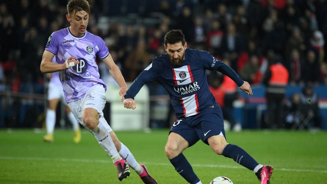 Paris Saint-Germain's Argentine forward Lionel Messi (R) fights for the ball with Toulouse's French defender Anthony Rouault. Credit: Reuters Photo