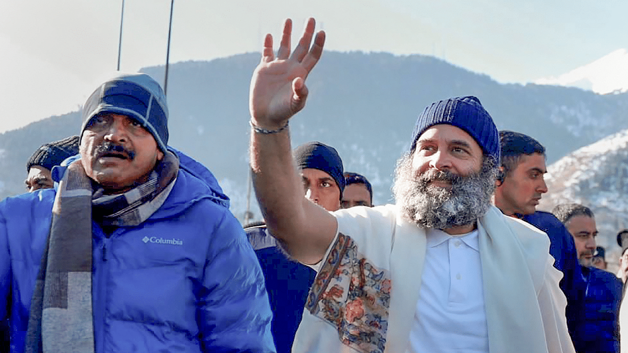 Congress leader Rahul Gandhi with party leader KC Venugopal waves at supporters during the party's Bharat Jodo Yatra in J&K's Banihal. Credit: PTI Photo