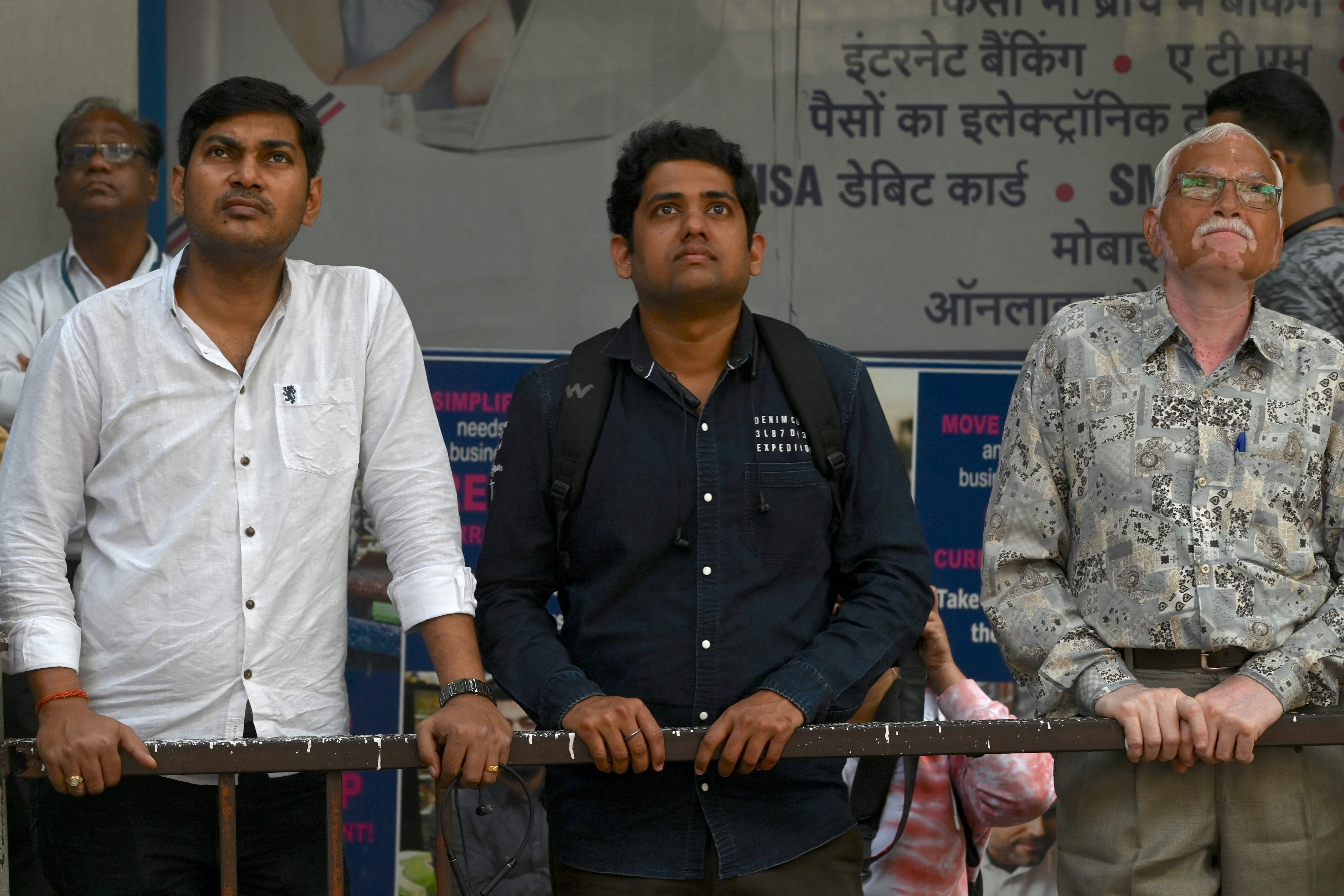 People look at the stock price movemnet at the Bombay Stock Exchange. Credit: AFP File Photo