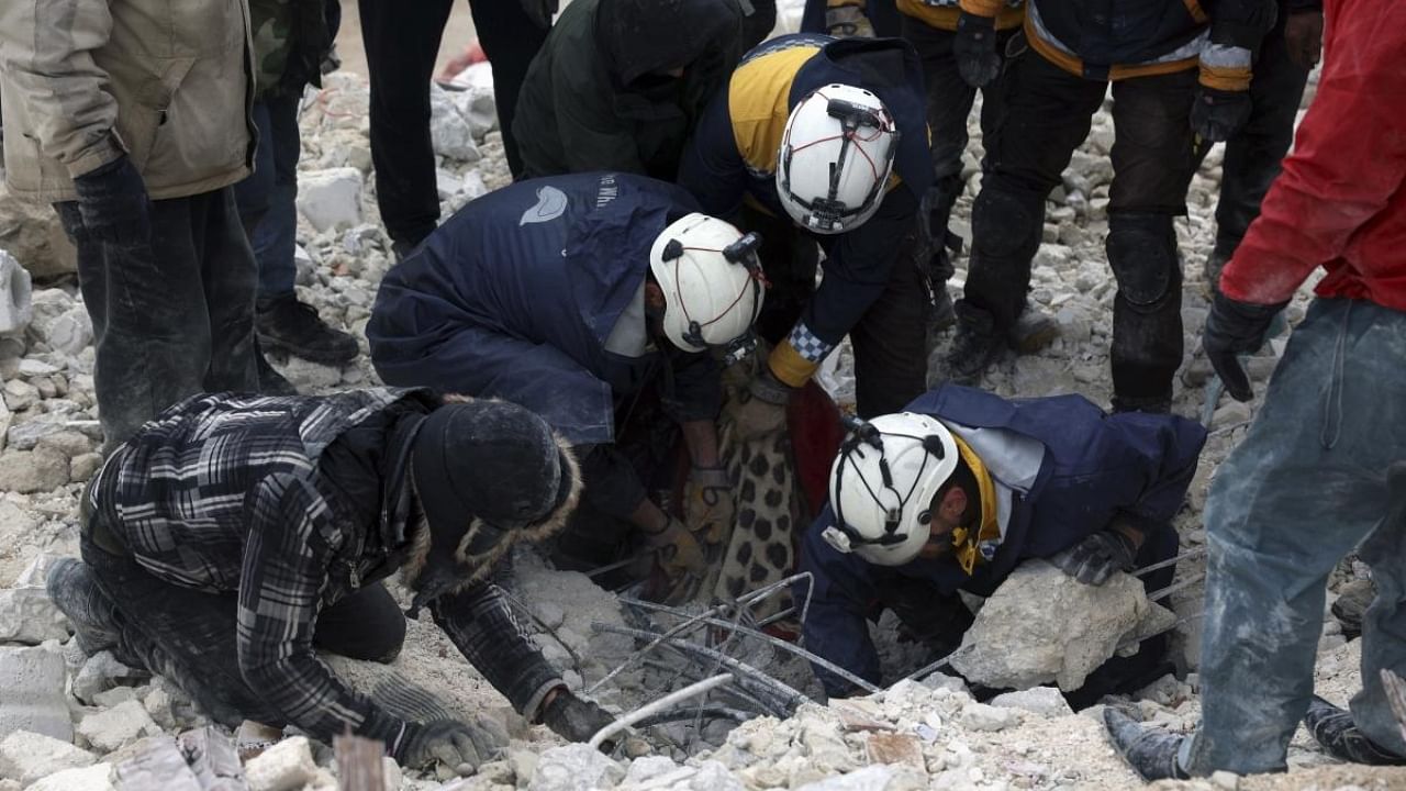 Civil defense workers search through the rubble of collapsed buildings in the Besnia village near the Turkish border, Idlib province, Syria, Monday, Feb. 6, 2023. Credit: AP/PTI Photos