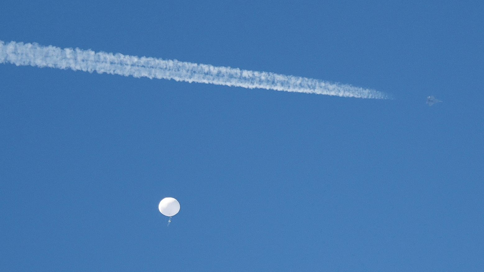  A jet flies by a suspected Chinese spy balloon. Credit: Reuters Photo