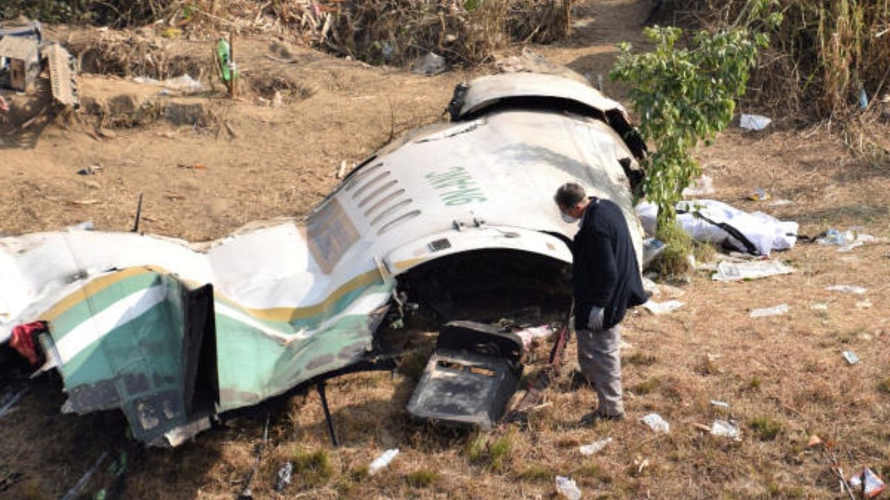  A member of French investigating team investigates the wreckage of a Yeti Airlines operated aircraft, in Pokhara, Nepal. Credit: Reuters Photo