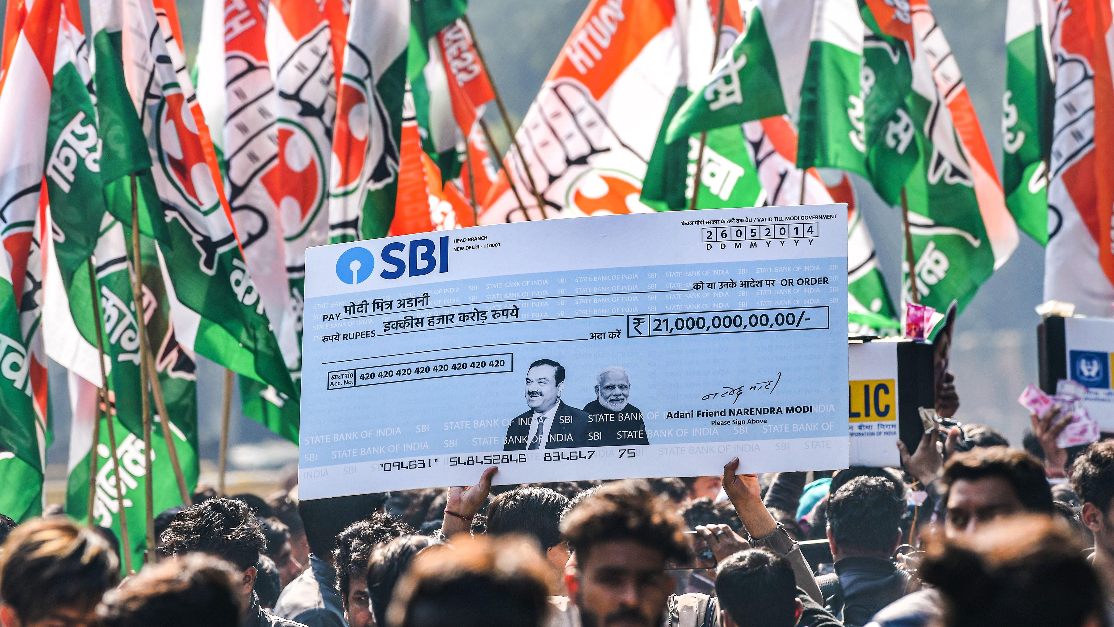 Indian Youth Congress activists stage a protest over the impact on LIC and SBI investors due to Adani row, at Jantar Mantar in New Delhi. Credit: PTI Photo