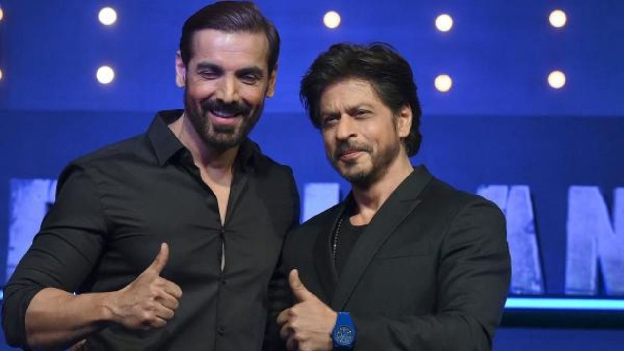 Bollywood actors John Abraham (L) and Shah Rukh Khan (R) pose during a media event of their ‘Pathaan’ in Mumbai. Credit: AFP Photo