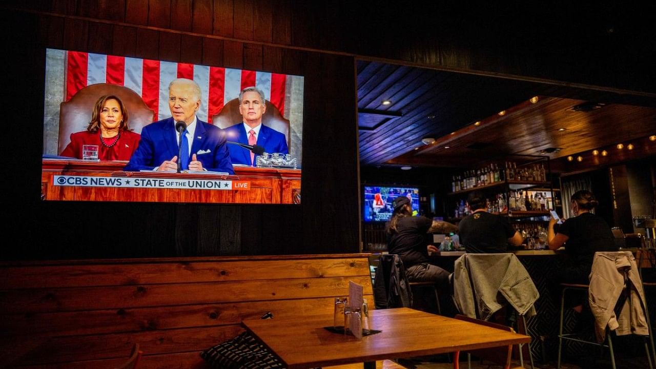 Americans across the nation watch President Biden's State Of the Union address. Credit: Getty Images via AFP