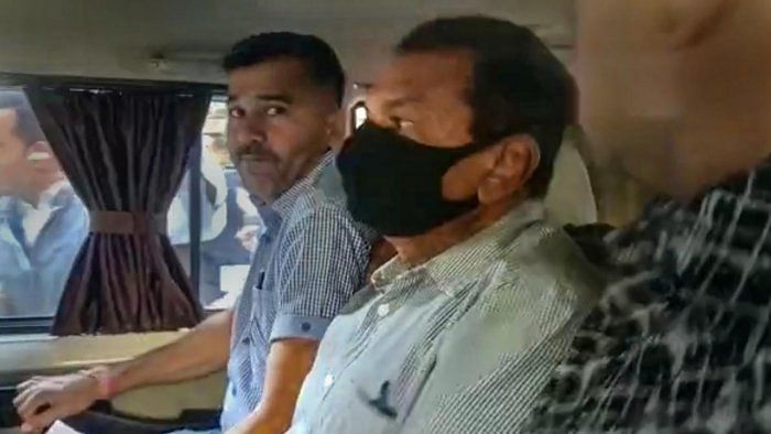 Police escort Owner of Oreva group Jaysukh Patel in connection with Bridge collapsed incident outside session court in Morbi. Credit: PTI Photo