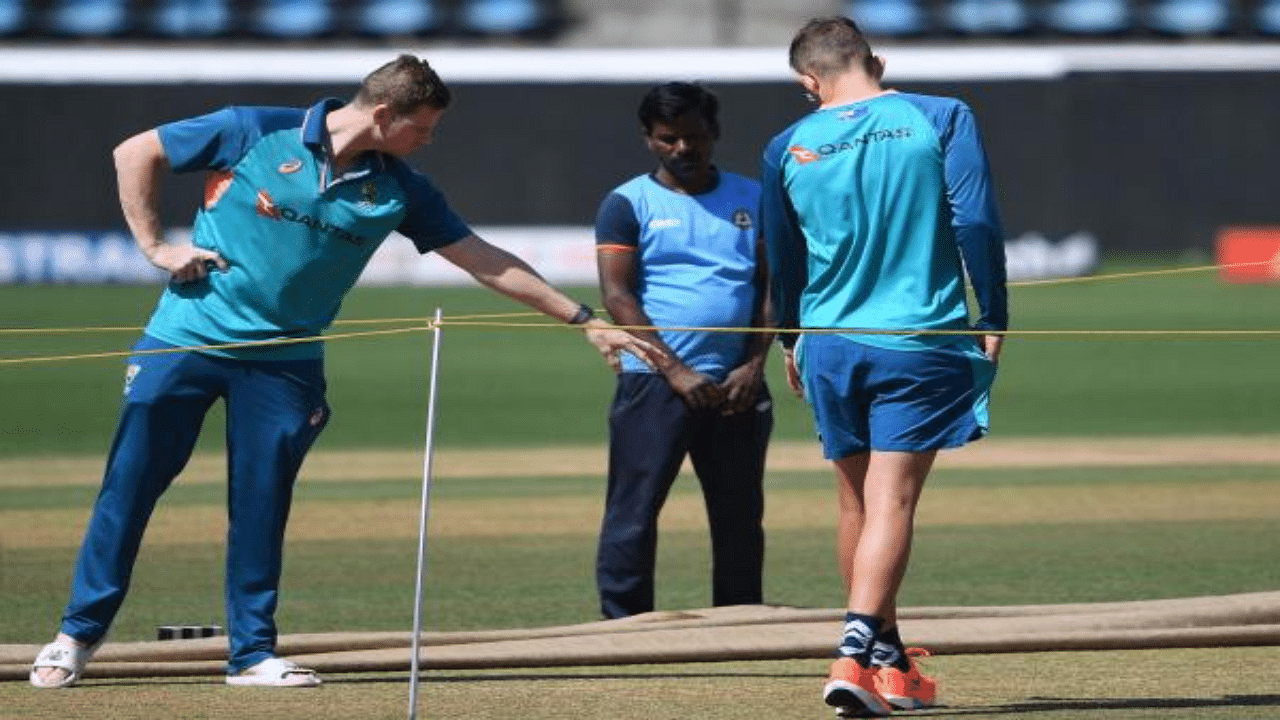 Australia's Steven Smith (L) inspects the picth during a practice session at the Vidarbha Cricket Association (VCA) Stadium in Nagpur on February 8, 2023. Credit: AFP Photo