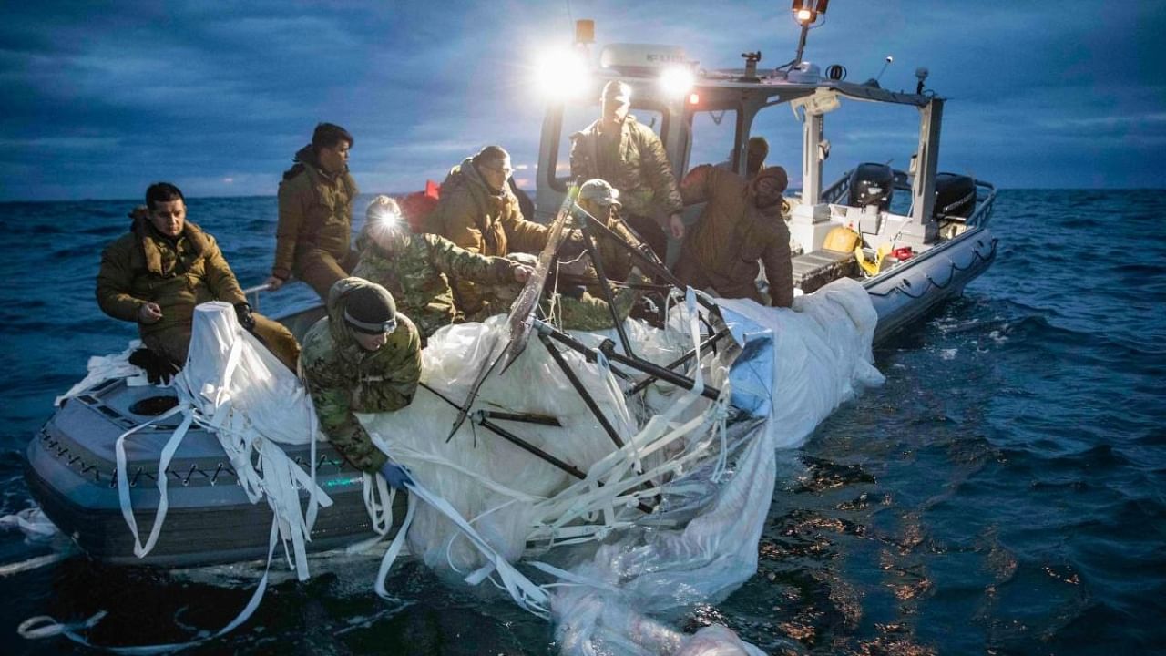 This picture provided by the US Navy shows sailors assigned to Explosive Ordnance Disposal Group 2 recover a high-altitude surveillance balloon off the coast of Myrtle Beach. Credit: AFP Photo