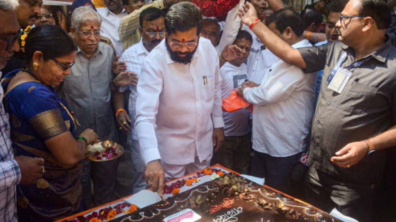 Maharashtra Chief Minister Eknath Shinde cuts a cake to celebrate his birthday. Credit: PTI Photo