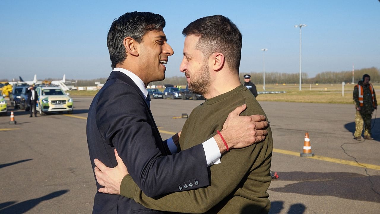 This handout photograph taken and released by the Ukrainian Presidential Press Service on February 8, 2023 shows Britain's Prime Minister Rishi Sunak (R) welcoming Ukraine's President Volodymyr Zelensky (L) for a meeting, at the London Stansted Airport. Credit: AFP Photo / Ukrainian Presidential Press Service 