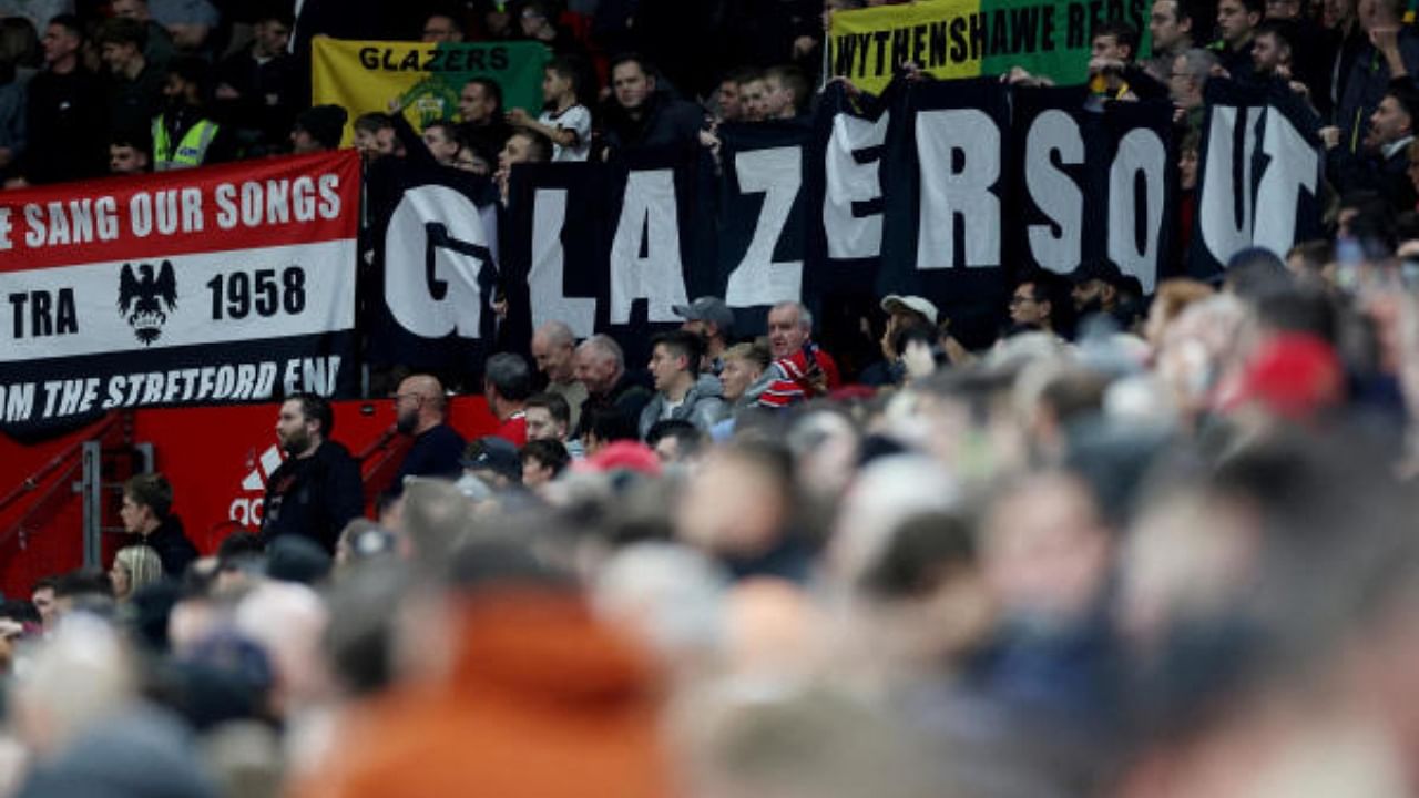 Manchester United fans display banners in protest of the Glazer family’s ownership of the club. Credit: Reuters File Photo