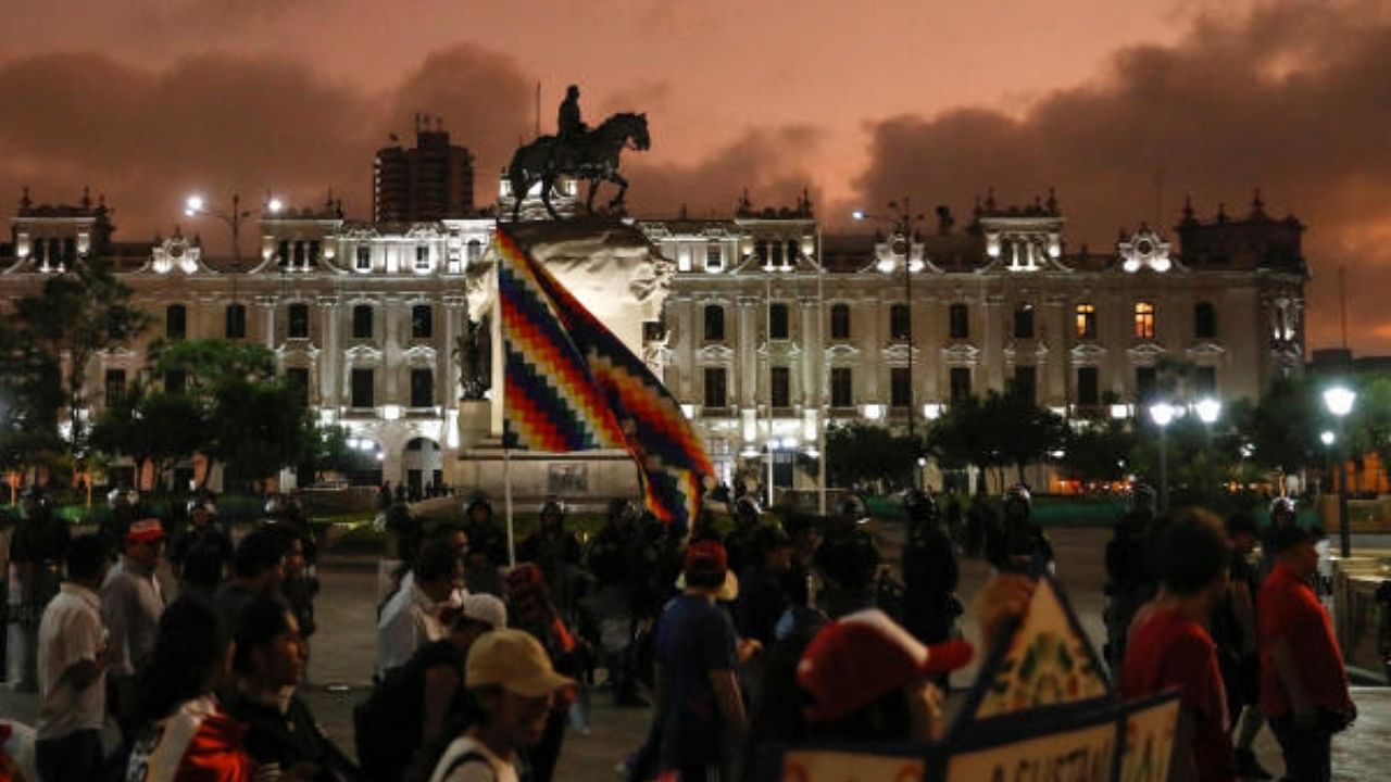 Demonstrators wave flags during a protest calling for an indefinite nationwide strike during a march against the government of Peru's President Dina Boluarte, in Lima, Peru. Credit: Reuters Photo