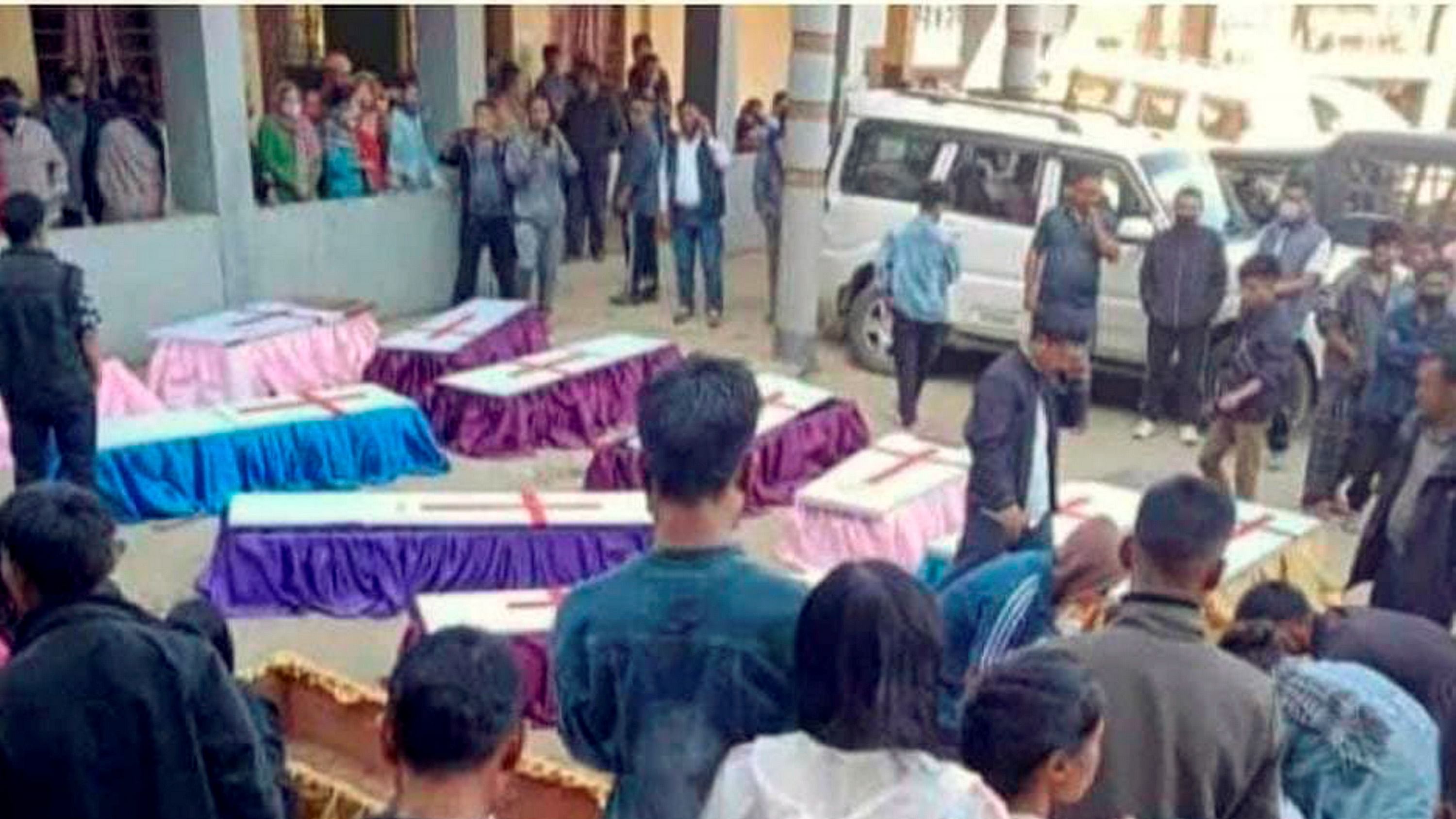 Locals and relatives stand near the bodies of 13 people who were allegedly killed by Armed Forces, in Mon district in 2021. Credit: PTI Photo