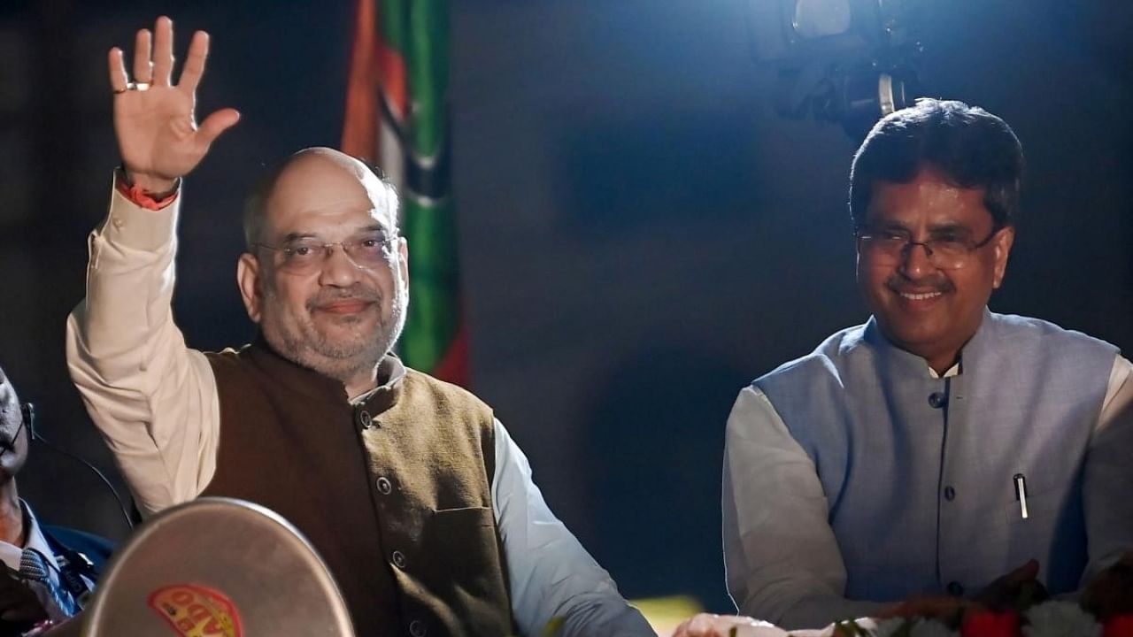 Union Home Minister Amit Shah along with Tripura CM Manik Saha during a road show organised ahead of the Tripura Assembly elections in Agartala. Credit: IANS Photo