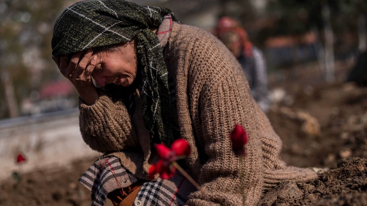 About 2,000 bodies have been identified at the cemetery, which is filled with freshly dug graves. Credit: AP Photo