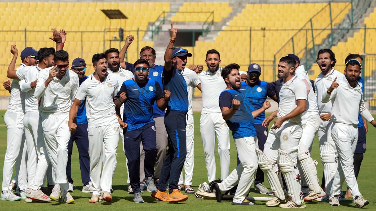 Saurashtra team coach Sitanshu Kotak, captain Arpit Vasavada with players celebrate after the team wins the 2nd semi final of Ranji Trophy. Credit: PTI Photo