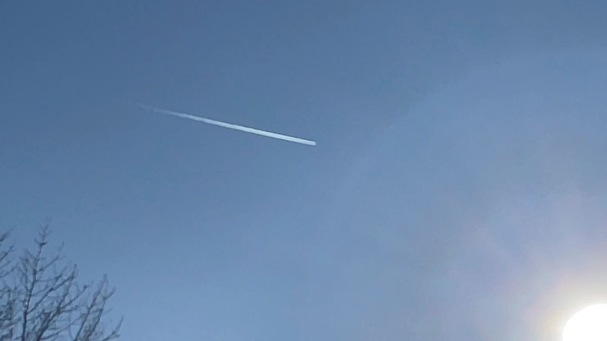A plane flies over Romulus, Michigan, U.S. February 12, 2023 in this still image obtained from social media video. Credit:  Reuters via SalehTrades