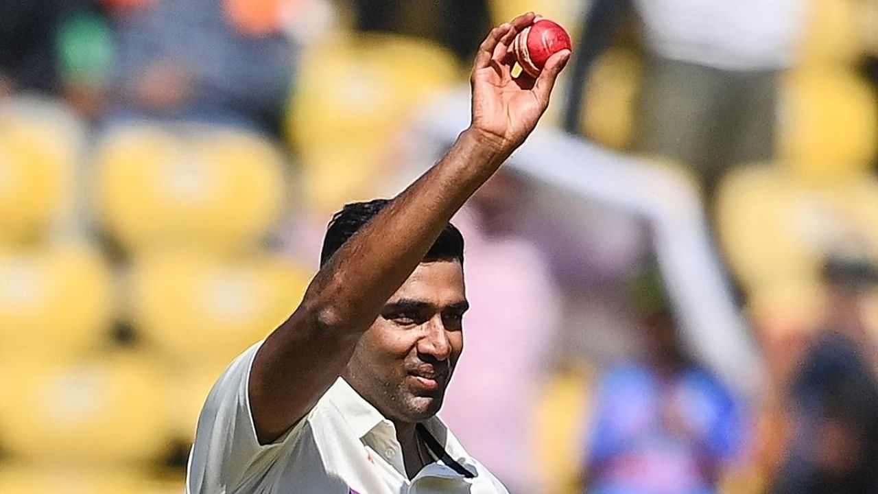 Ravichandran Ashwin raises the ball after taking five wickets during the third day of the first Test cricket match between India and Australia. Credit: AFP Photo