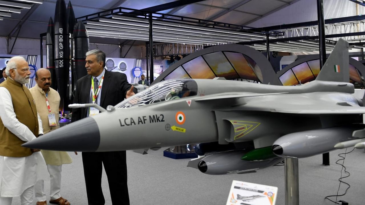 Prime Minister Narendra Modi visits an exhibition stall set up on the sidelines of Aero India show in Bengaluru on Monday. Credit: PIB Photo