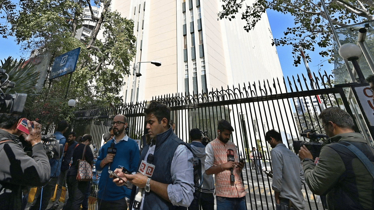 Media persons stand outside the office of BBC during a raid by the Income Tax authorities in New Delhi. Credit: IANS Photo