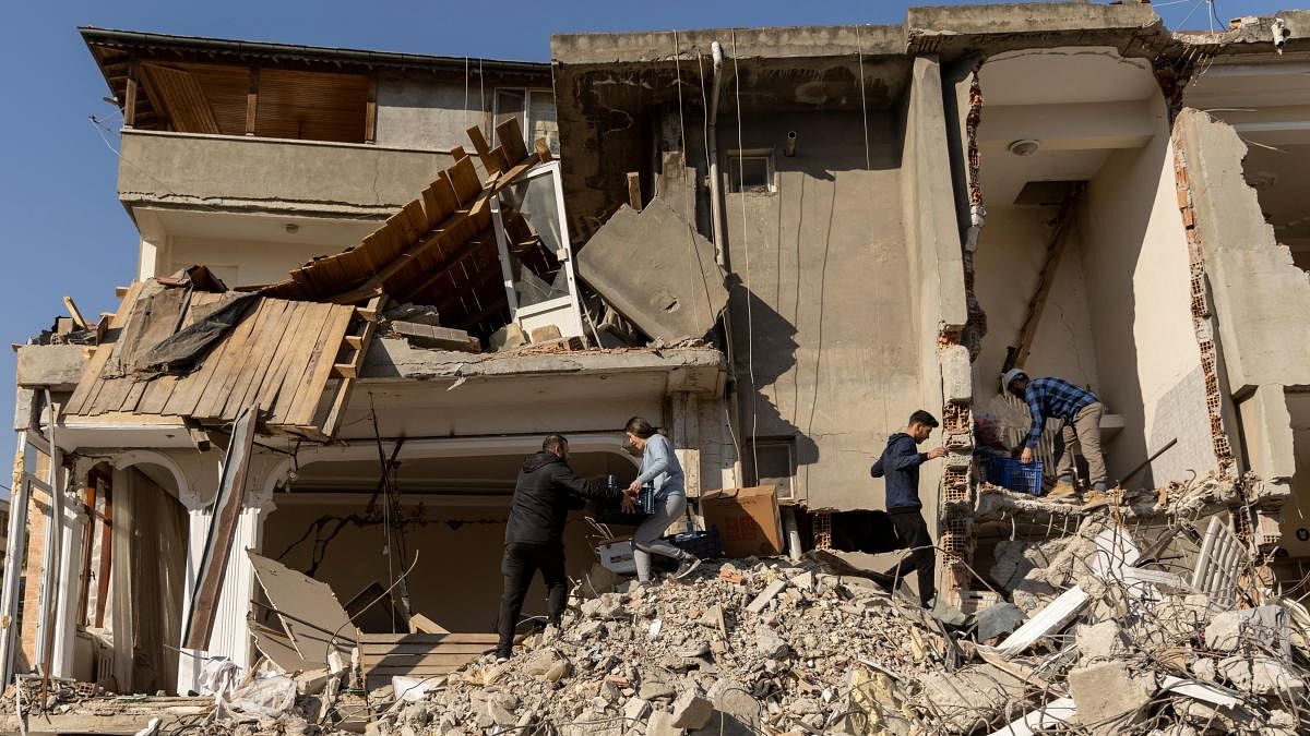 People gather items from the rubble following the deadly earthquake in Hatay province, Turkey. Credit: Reuters Photo