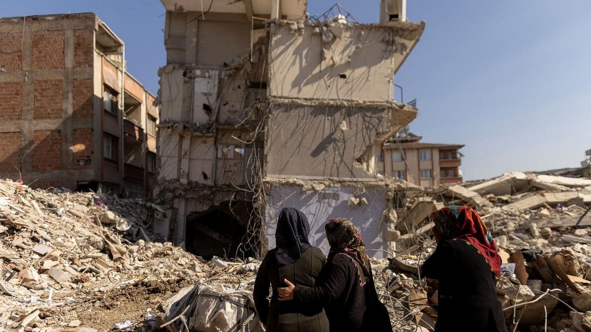 Women look at what is left of their home following the deadly earthquake in Hatay province, Turkey. Credit: Reuters Photo
