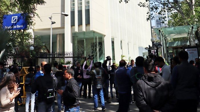 Media persons stand outside the office of BBC during a raid by the Income Tax authorities in New Delhi. Credit: IANS Photo