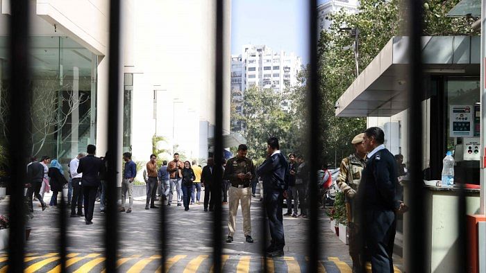Police officers stand outside a building having BBC offices, where income tax officials are conducting a search, in New Delhi, India. Credit: Reuters Photo