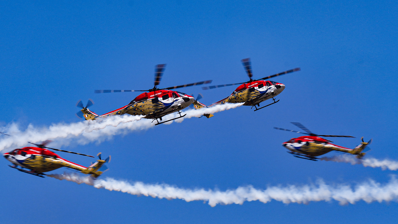 Helicopters of the Indian Air Force's aerobatic team 'Sarang' perform during the third day of Aero India 2023. Credit: PTI Photo