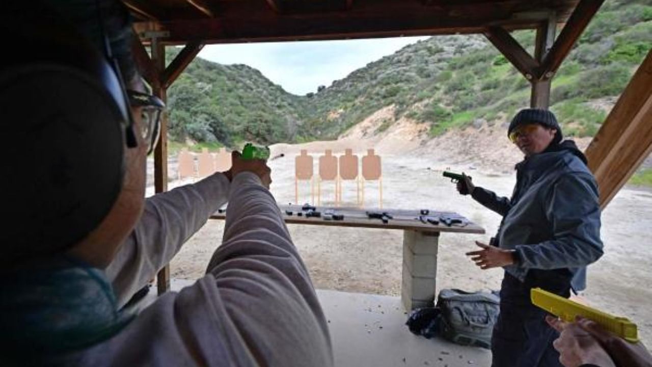 Gun instructor Tom Nguyen (R) teaches students during a Defensive Pistol Class at Burro Canyon Shooting Park in Azusa, California, on February 12, 2023. Credit: AFP Photo