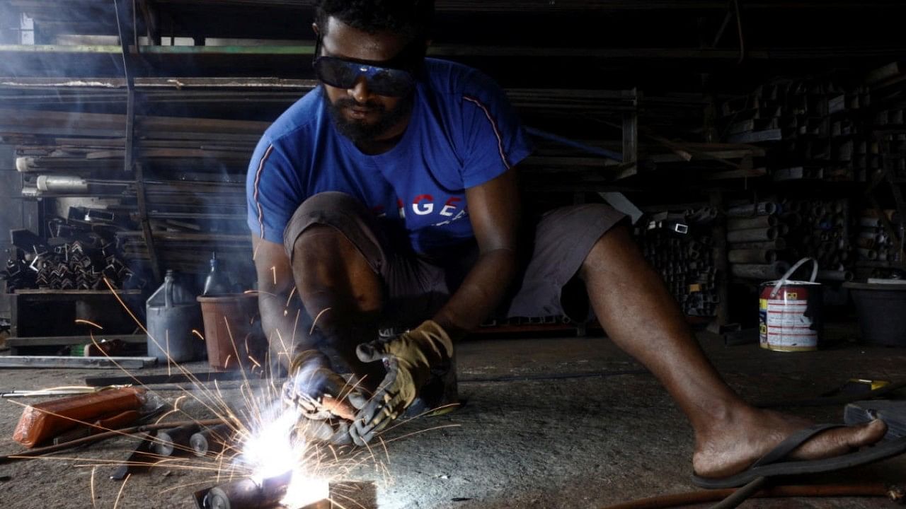 A man works at a welding shop, after the government announced a hike in power prices by 66% from today onwards, in Colombo, Sri Lanka. Credit: Reuters Photo
